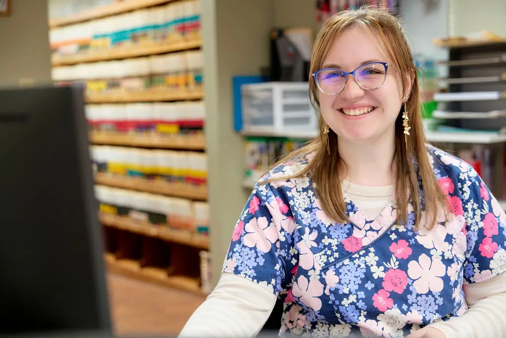 Staff smiles at the front desk of Animal Care Center in Princeton and Pearisburg.